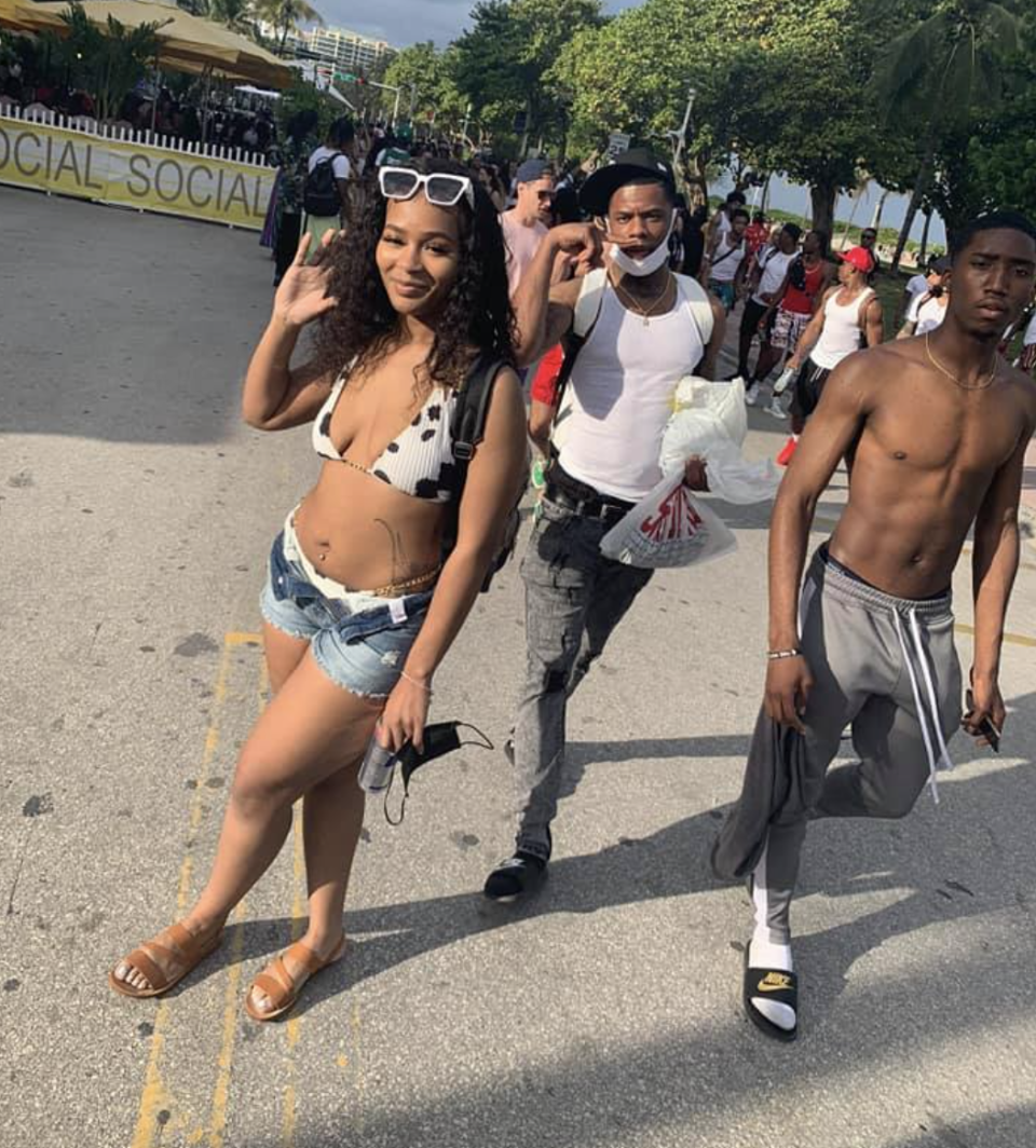 De'Asia Skillern (left) poses in a bikini while Dorian Taylor (centre) and Evoire Collier (right) are seen in the background. 