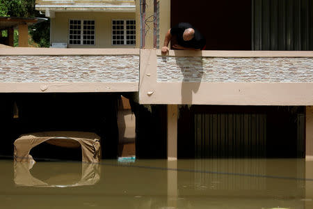 A man looks at damage to his flooded house, close to the dam of the Guajataca lake. REUTERS/Carlos Garcia Rawlins