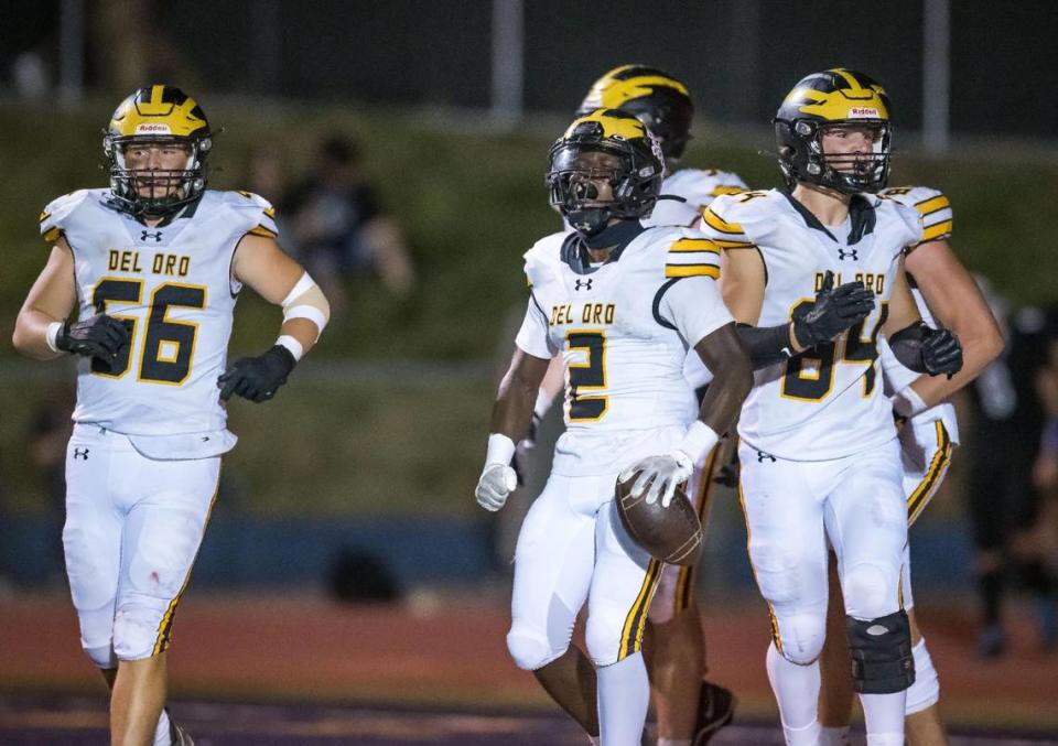 Del Oro Golden Eagles Marcel Urquhart (2), center, celebrates scoring in the third quarter against the Casa Roble Rams at the high school football game Friday at Casa Roble High School.