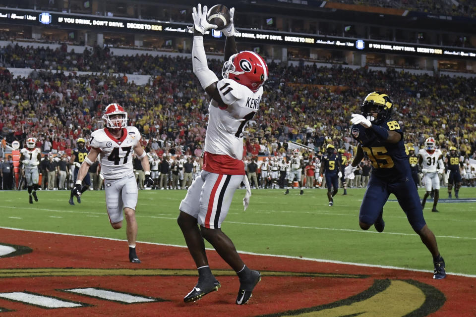 Georgia defensive back Derion Kendrick intercepts a pass intended for Michigan wide receiver Daylen Baldwin during the second half of the Orange Bowl NCAA College Football Playoff semifinal game, Friday, Dec. 31, 2021, in Miami Gardens, Fla. (AP Photo/Jim Rassol)