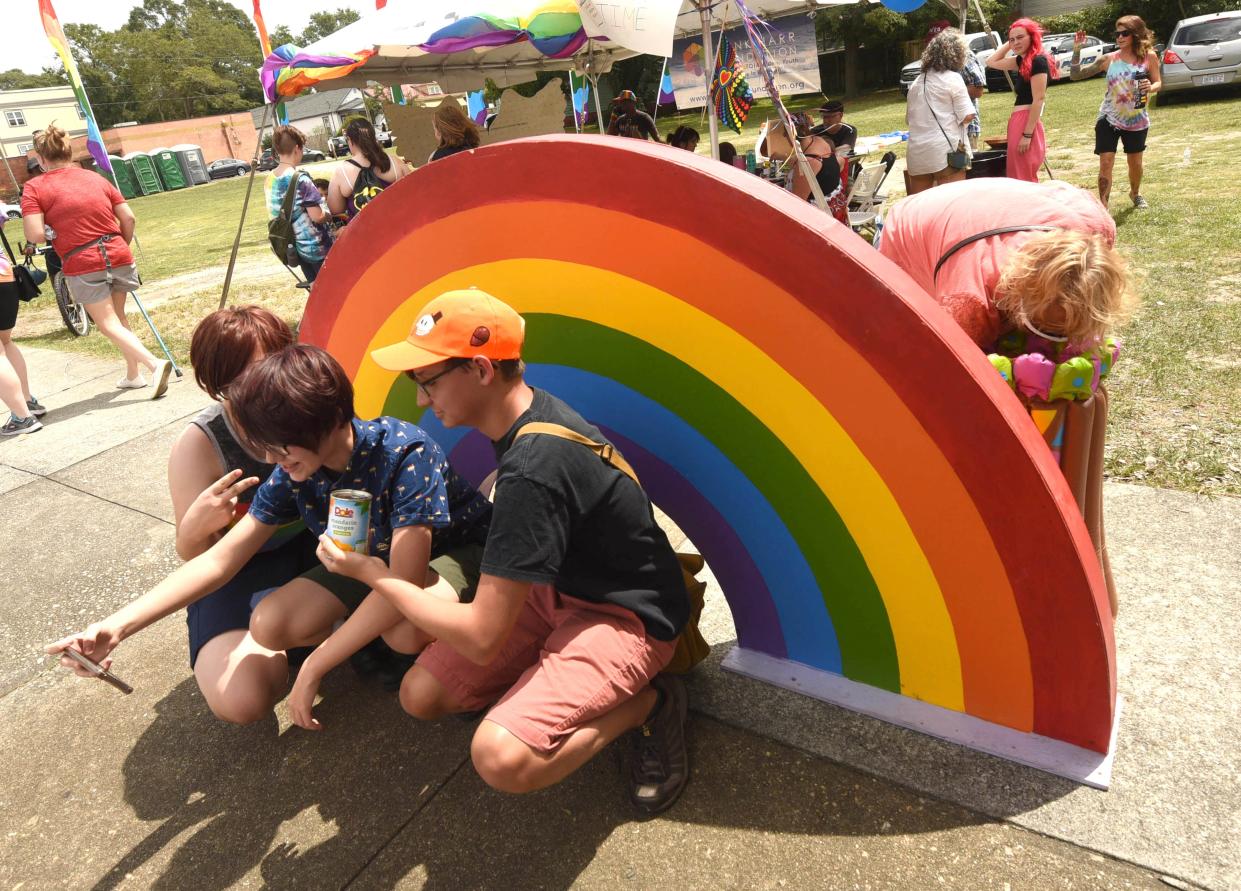 People pose for photos during the Port City Pride Celebration in June 2019 in Wilmington, NC.