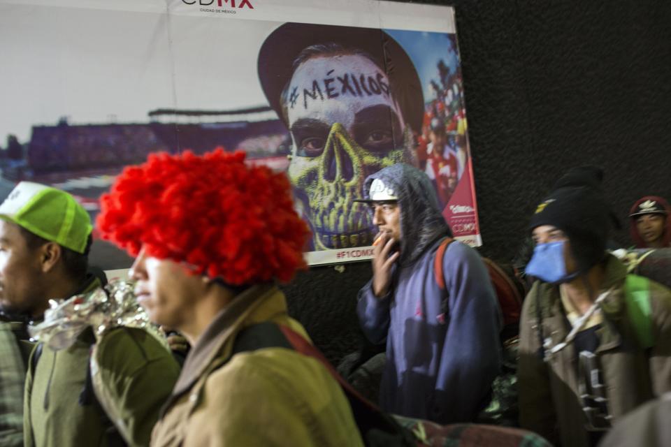 A Central American migrant walks to the subway after leaving the temporary shelter at the Jesus Martinez stadium, in Mexico City, Friday, Nov. 9, 2018. About 500 Central American migrants headed out of Mexico City on Friday to embark on the longest and most dangerous leg of their journey to the U.S. border, while thousands more were waiting one day more at the stadium. (AP Photo/Rodrigo Abd)