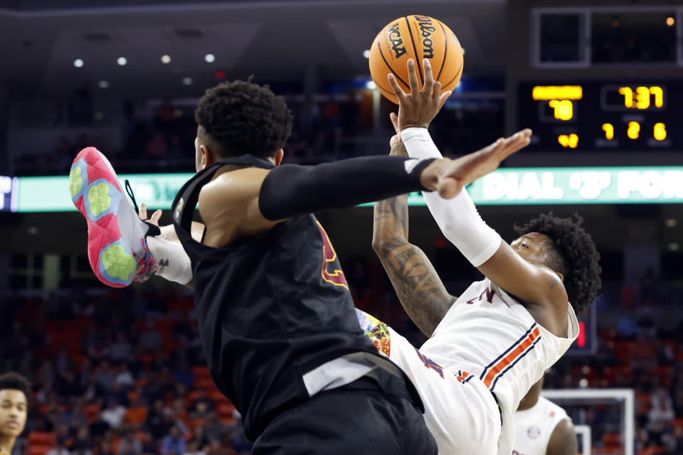 Auburn guard Wendell Green Jr. (1) shoots while falling, as Winthrop guard Isaiah Wilson (21) defends during the second half of an NCAA college basketball game Tuesday, Nov. 15, 2022, in Auburn, Ala. (AP Photo/Butch Dill)