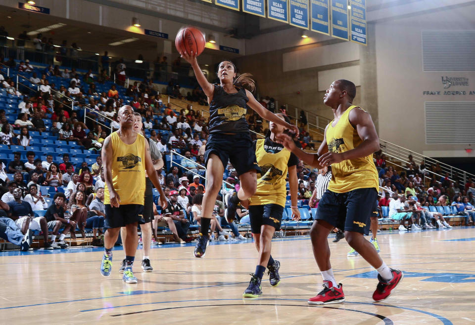 Harlem Globetrotter Tammy Brawner drives to the hoop during the 14th annual Duffy's Hope Celebrity Basketball Game last year.