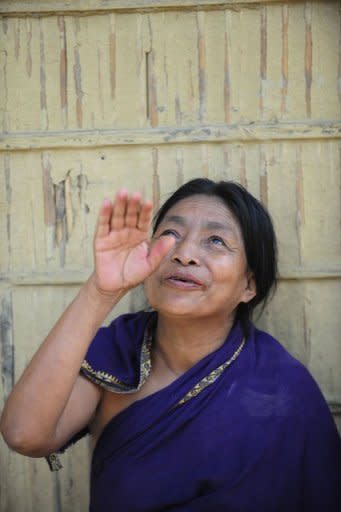 An elder of the Patra tribe sings a traditional song in Daliopara, near Dhaka. Experts believe the loss of tribal languages verges on "cultural genocide" given the loss of identity that inevitably follows