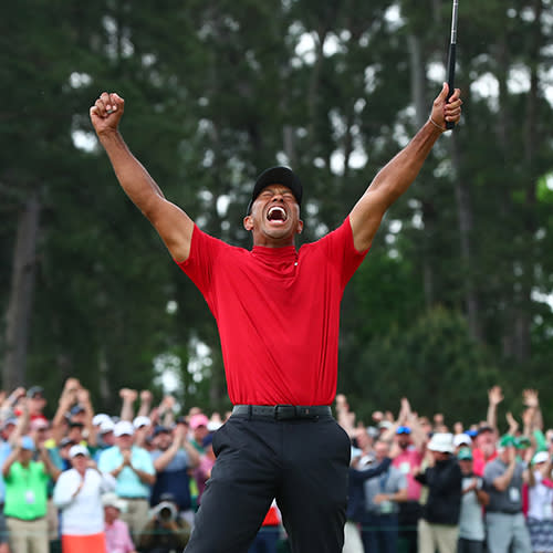 Tiger Woods celebrates after making a putt on the 18th green to win The Masters golf tournament at Augusta National Golf Club