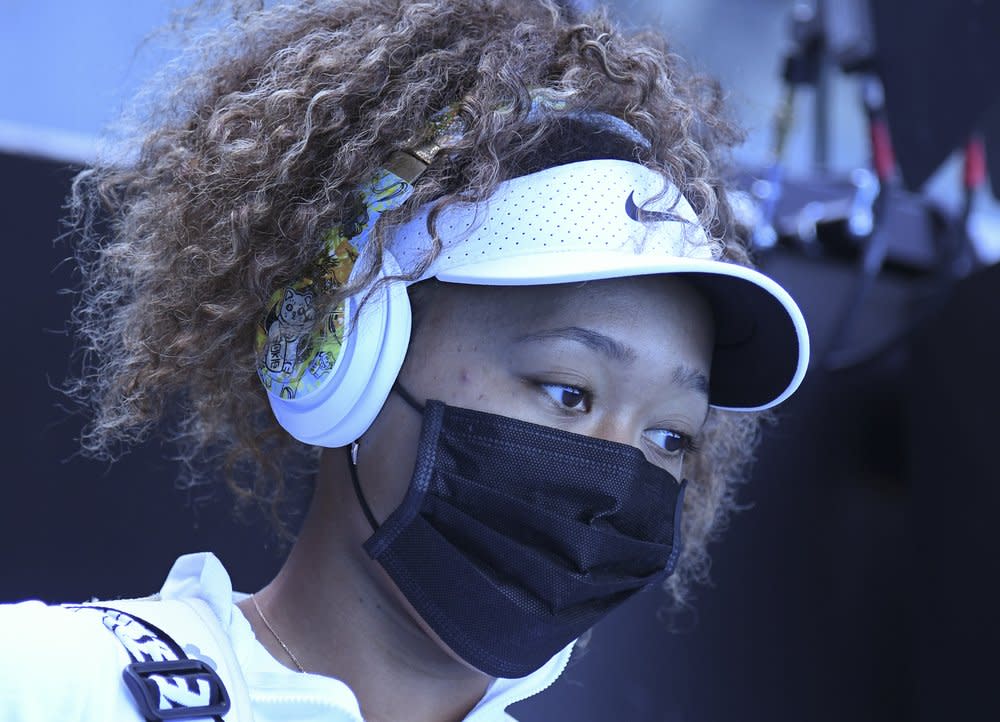 Japan’s Naomi Osaka walks out onto court for her match against Britain’s Katie Boulter during a tuneup event ahead of the Australian Open tennis championships in Melbourne, Australia, Wednesday, Feb. 3, 2021. (AP Photo/Andy Brownbill)