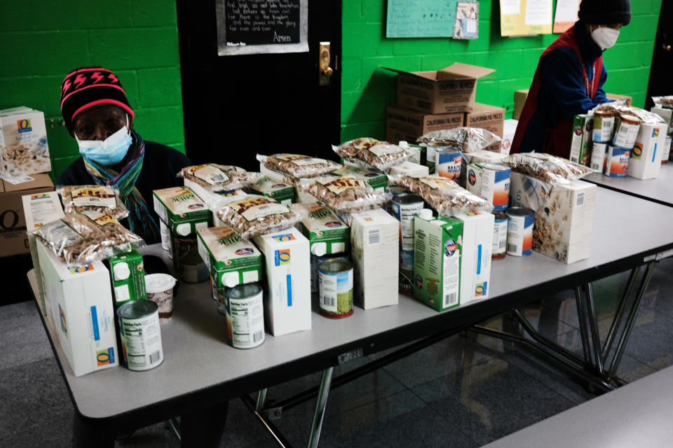 NEW YORK, NEW YORK - MARCH 10: Volunteers prepare food at a food distribution for the poor inside of a church in the South Bronx on March 10, 2021 in New York City. The South Bronx, which had one of the highest Covid-19 infection rates in New York City, is also home to an estimated 60% of New York City's very low income residents.  (Photo by Spencer Platt/Getty Images)