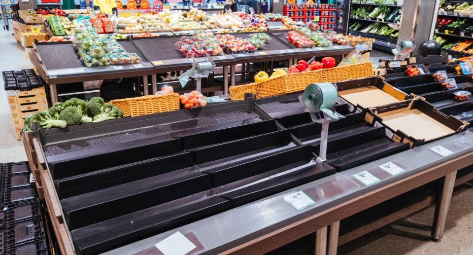 Empty produce shelf in a Woolworths store