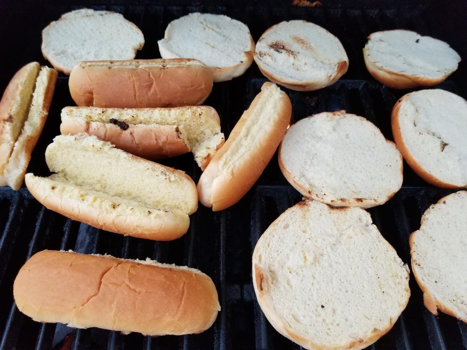 Hot dog and hamburger buns on grill