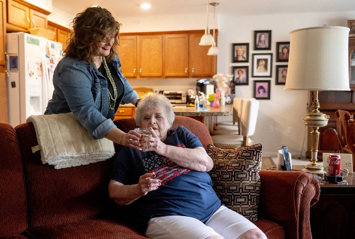 Death doula Ashley Boydston gave a glass of water to Jeannine Binder after the two women took a walk outside Binder’s home in Shawnee. Nick Wagner/nwagner@kcstar.com