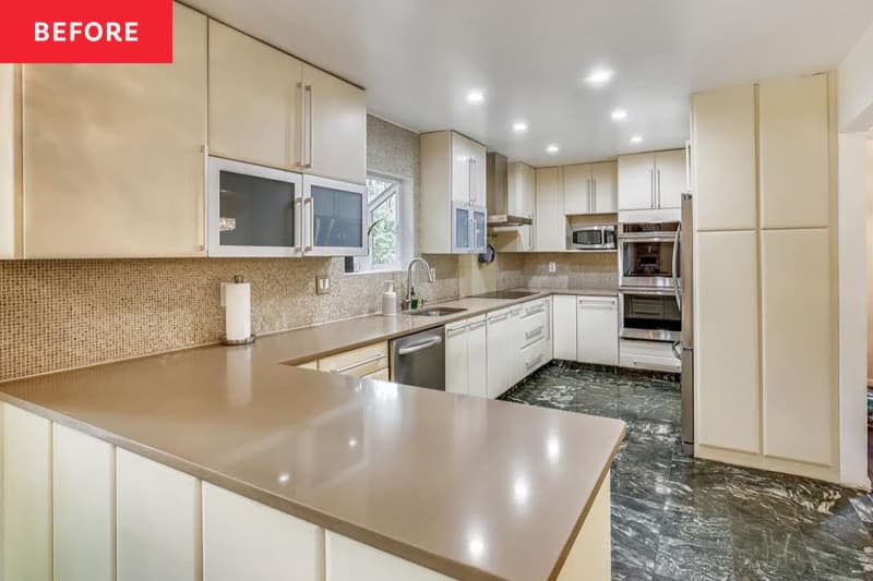 Cream colored cabinets in kitchen before renovation.