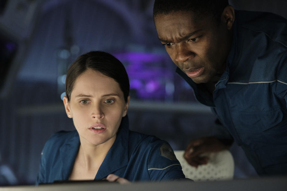 This image released by Netflix shows Felicity Jones, left, and David Oyelowo in a scene from "The Midnight Sky." (Philippe Antonello/Netflix via AP)