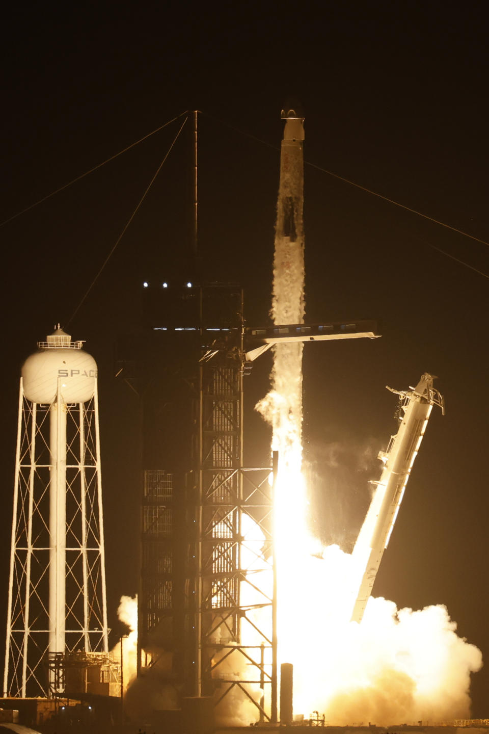 A SpaceX Falcon 9 rocket with the Crew Dragon spacecraft with astronauts on a mission to the International Space Station lifts off from pad 39A at Kennedy Space Center in Cape Canaveral, Fla., Saturday, Aug. 26, 2023. (AP Photo/Terry Renna)