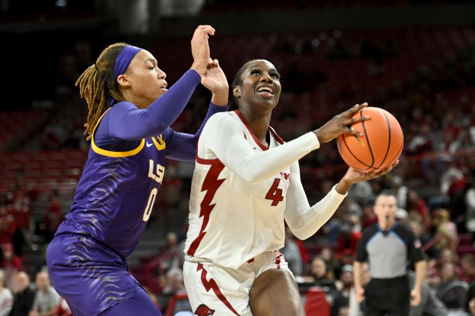 Arkansas forward Erynn Barnum (4) triers to drive past LSU forward LaDazhia Williams (0) during an NCAA basketball game on Thursday, Dec. 29, 2022, in Fayetteville, Ark. (AP Photo/Michael Woods)