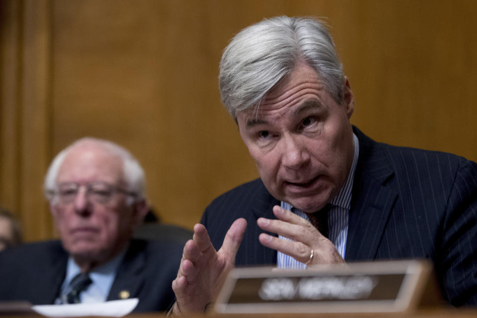 Sen. Sheldon Whitehouse (D-R.I.), right, accompanied by Sen. Bernie Sanders, (I-Vt.), left, questioned Wheeler at the hearing.  (Associated Press)