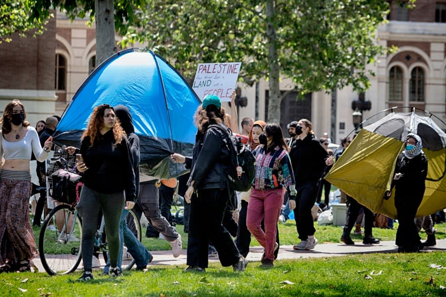 University of Southern California protesters carry a tents around Alumni Park on the campus of the University of Southern California to keep security from removing them during a pro-Palestinian occupation on Wednesday, April 24, 2024 in Los Angeles. (AP Photo/Richard Vogel)