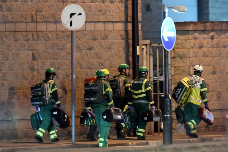 Medics arrive at the scene of the suspected explosion at an Ariana Grande pop concert in Manchester, Britain