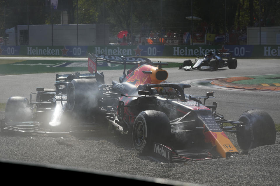 Red Bull driver Max Verstappen of the Netherlands, right and Mercedes driver Lewis Hamilton of Britain crash during the Italian Formula One Grand Prix, at Monza racetrack, in Monza, Italy, Sunday, Sept.12, 2021. (AP Photo/Luca Bruno)