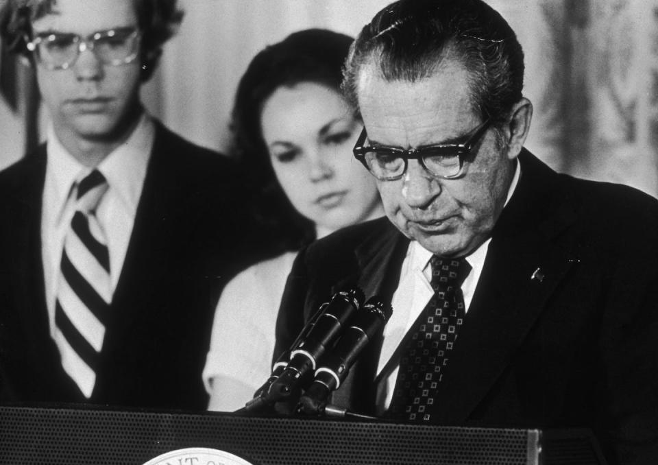 U.S. President Richard Nixon at a White House lectern reading a farewell speech to his staff following his resignation on Aug. 9, 1974. <a href="https://www.gettyimages.com/detail/news-photo/president-richard-nixon-looks-down-as-stands-at-a-podium-news-photo/3245056?adppopup=true" rel="nofollow noopener" target="_blank" data-ylk="slk:George Tames/New York Times Co./Getty Images;elm:context_link;itc:0;sec:content-canvas" class="link ">George Tames/New York Times Co./Getty Images</a>