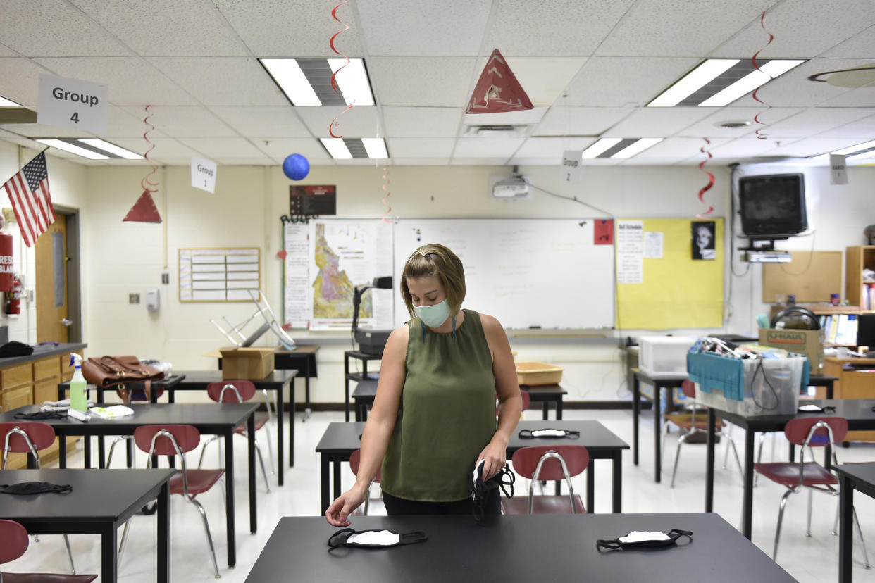 Science teacher Camille Flournoy sets out masks for her students Tuesday, Aug. 18, 2020, at a middle school in Twin Falls, Idaho. Flournoy and other teachers are now officially considered "essential workers." (Drew Nash/Times-News via AP)