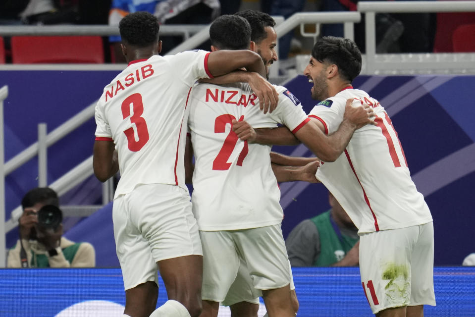 Jordan's Yazan Alnaimat, right, celebrates after scoring his side's opening goal during the Asian Cup semifinal soccer match between South Korea and Jordan at Ahmad Bin Ali Stadium in Al Rayyan, Qatar, Tuesday, Feb. 6, 2024. (AP Photo/Aijaz Rahi)