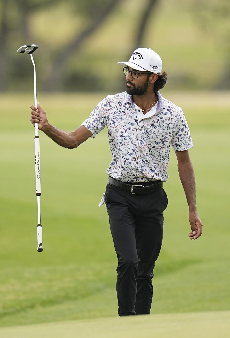 Akshay Bhatia waves to the gallery as he walks to the 18th green during the third round of the Texas Open golf tournament, Saturday, April 6, 2024, in San Antonio. (AP Photo/Eric Gay)
