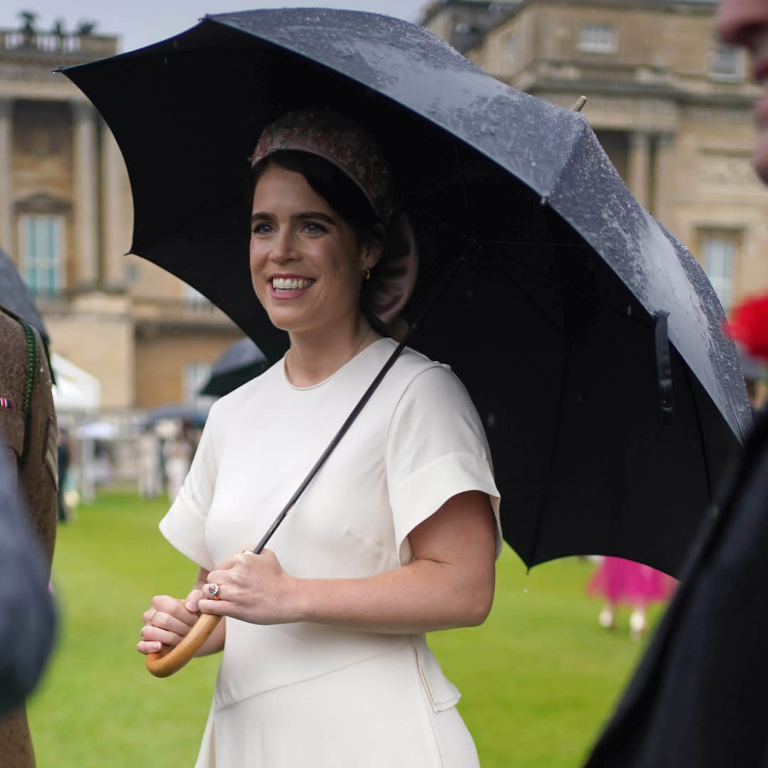  Princess Eugenie wears a white wrap dress at a garden party appearance in London. 