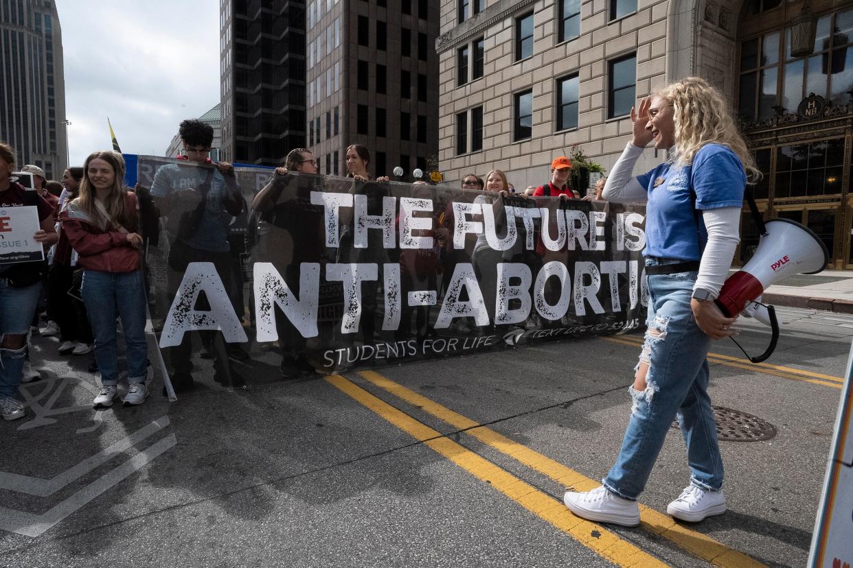 Members of Students For Life hold a banner before the March for Life in Columbus on Oct. 6.