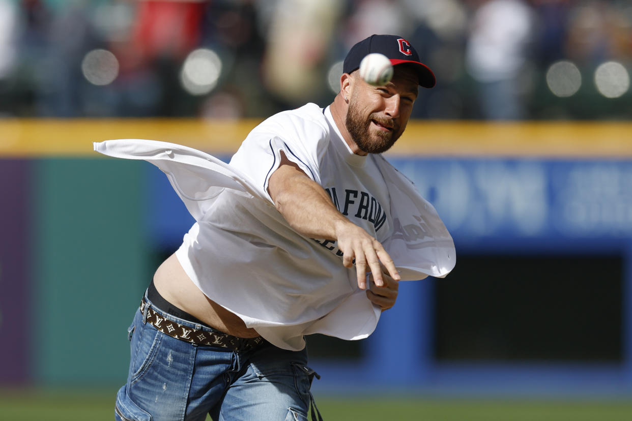 Kansas City Chiefs tight end Travis Kelce throws out the ceremonial first pitch before a baseball game between the Cleveland Guardians and the Seattle Mariners, Friday, April 7, 2023, in Cleveland. (AP Photo/Ron Schwane)