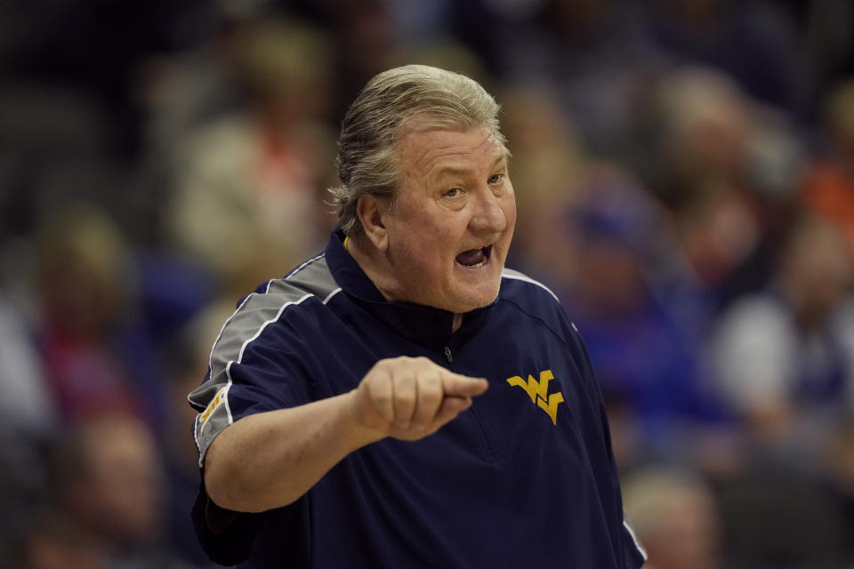 West Virginia head coach Bob Huggins talks to his players during the first half of an NCAA college basketball game against Texas Tech in the first round of the Big 12 Conference tournament Wednesday, March 8, 2023, in Kansas City, Mo. (AP Photo/Charlie Riedel)