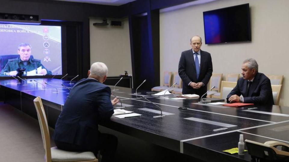 Swimming pool photograph distributed by the Russian state agency Sputnik, Russian Defense Minister Andrei Belousov (2nd L) and the director of the Federal Security Service (FSB) of the Russian Federation, Alexander Bortnikov (3rd L), together with the Secretary of Security Council of the Russian Federation Sergei Shoigu listens to Chief of the General Staff of the Armed Forces of the Russian Federation Valery Gerasimov (L) seen on a screen while remotely participating in a meeting with heads of law enforcement agencies to address the situation in the Kursk region of Moscow on August 7, 2024.