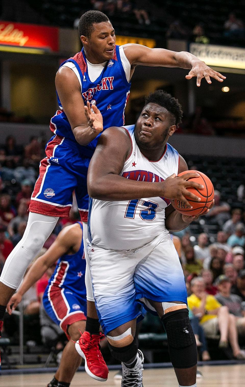 Ben Davis's Dawand Jones (13) drives for a layup against Kentucky's Isaiah Cozart (9) during the Indiana All-Stars vs. Kentucky All-Stars game on June 8, 2019, in Indianapolis.