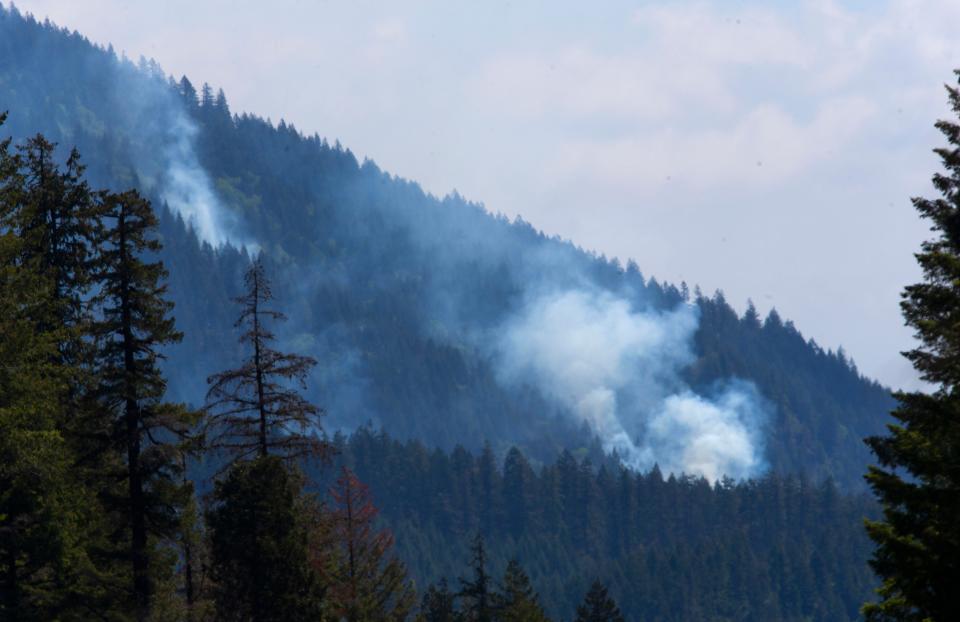 A fire that had started as a prescribed burn is seen on the hillside northeast of McKenzie Bridge on Wednesday.