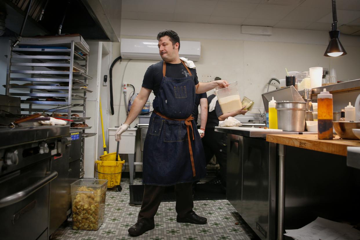 Chef and restaurant owner Joe Tripp prepares food during a lunch rush at Little Brother in Windsor Heights.