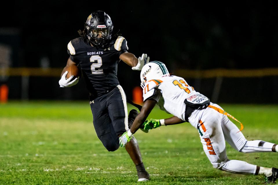 Buchholz Bobcats middle linebacker Myles Graham (2) stiff arms Eastside Rams strong safety DJ Anderson (11) during the first half at Citizens Field in Gainesville, FL on Friday, September 8, 2023. [Matt Pendleton/Gainesville Sun]