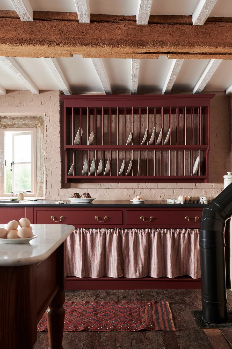 <p> If you are looking to create a&#xA0;rustic kitchen ideas&#xA0;that are created from freestanding furniture from disparate sources and even periods, you can conjure up a cohesive, more uniform look with the clever use of paint. Here,&#xA0;freestanding kitchen&#xA0;cabinets and a plate rack have simply but cleverly been visually linked with&#xA0;kitchen colour ideas&#xA0;to match. </p> <p> &apos;You needn&apos;t pick exactly the same color for different pieces of painted furniture,&apos; says&#xA0;<em>Homes &amp; Gardens</em>&apos; Editor in Chief Lucy Searle. &apos;Simply choosing differing tones of the same color can create a more layered look. If you are applying this technique to a kitchen, it is always more space-enhancing to put the darker tone on the base units, and the lighter shade on the wall cabinets.&apos; </p>