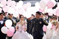 A total of 188 couples walk in the venue during a military mass wedding in Taoyuan,
