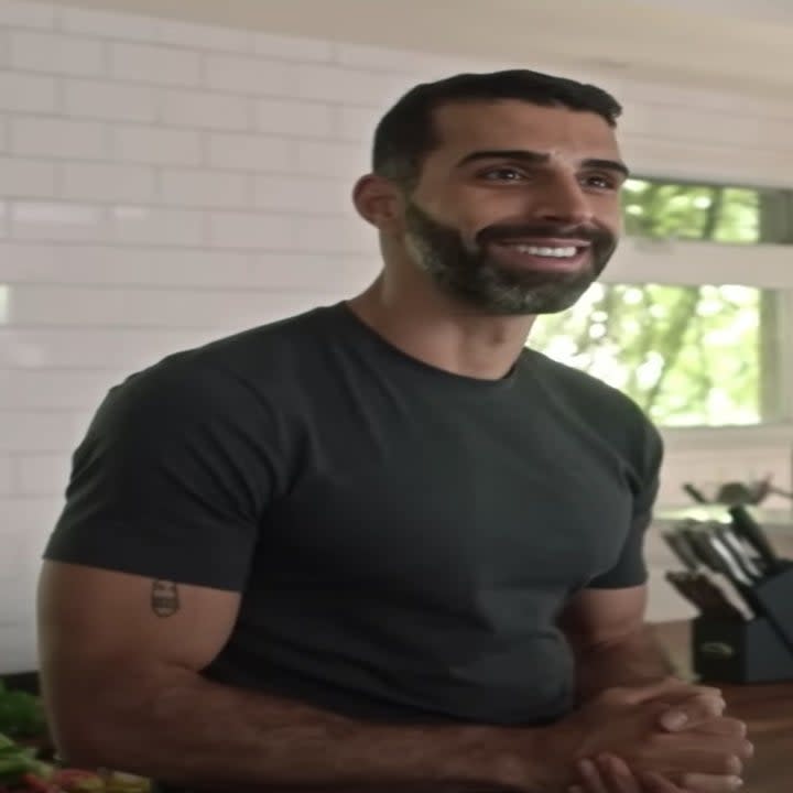 Samer Salem smiles in a kitchen.