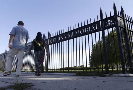 Thomas and Carol Muniz, of Tulsa, Oklahoma, walk past the entrance to the New Orleans Katrina Memorial in New Orleans, Louisiana, August 23, 2015. REUTERS/Jonathan Bachman