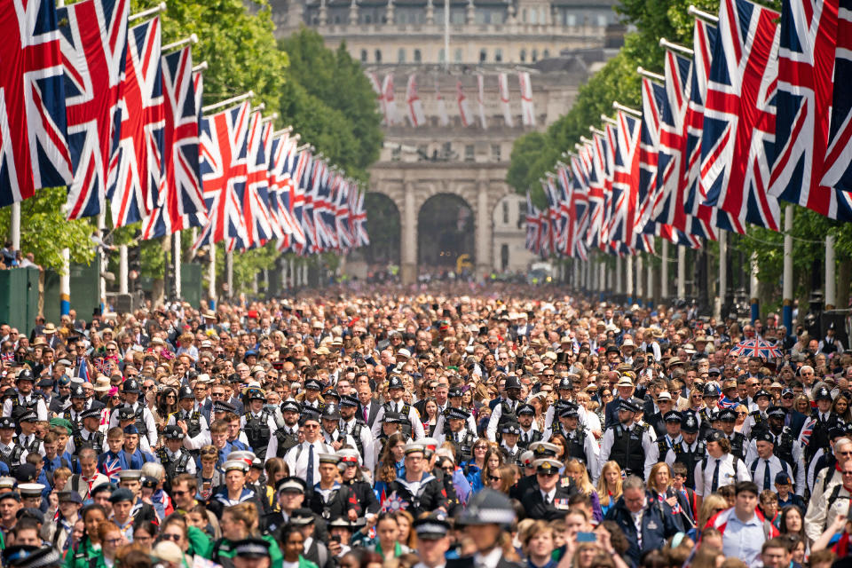 Crowds on The Mall watch, as Queen Elizabeth II makes an appearance on the balcony of Buckingham Palace during Trooping The Colour in London, on June 2, 2022.<span class="copyright">Aaron Chown—WPA Pool/Getty Images</span>