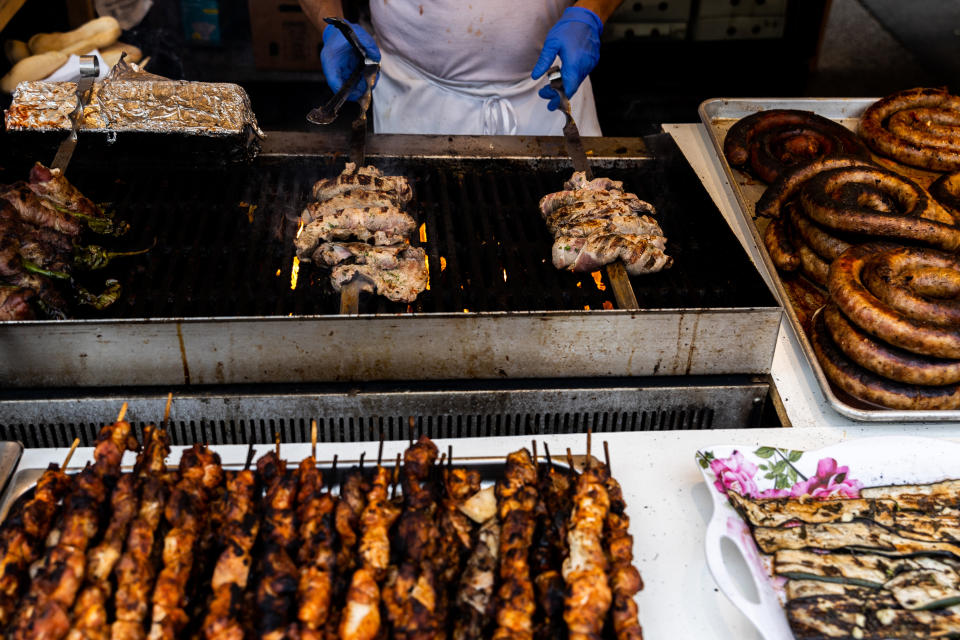 Food vendors sell sausage, pepper and onions during the Giglio feast, Sunday, July 17, 2022, in the Brooklyn borough of New York. (AP Photo/Julia Nikhinson)