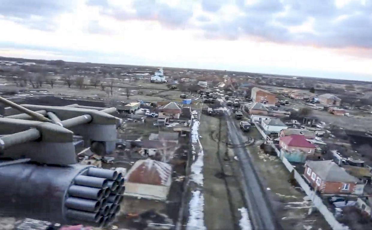 This image taken from video released by Russian Defense Ministry Press Service on Tuesday, March 1, 2022, shows a view from the window of a Russian military helicopter as it flies over an undisclosed location in Ukraine.