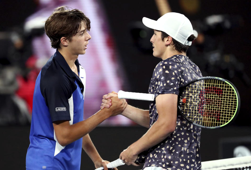 France's Harold Mayot, right, is congratulated by compatriot Arthur Cazaux after winning the junior boys final against at the Australian Open tennis championship in Melbourne, Australia, Saturday, Feb. 1, 2020. (AP Photo/Dita Alangkara)