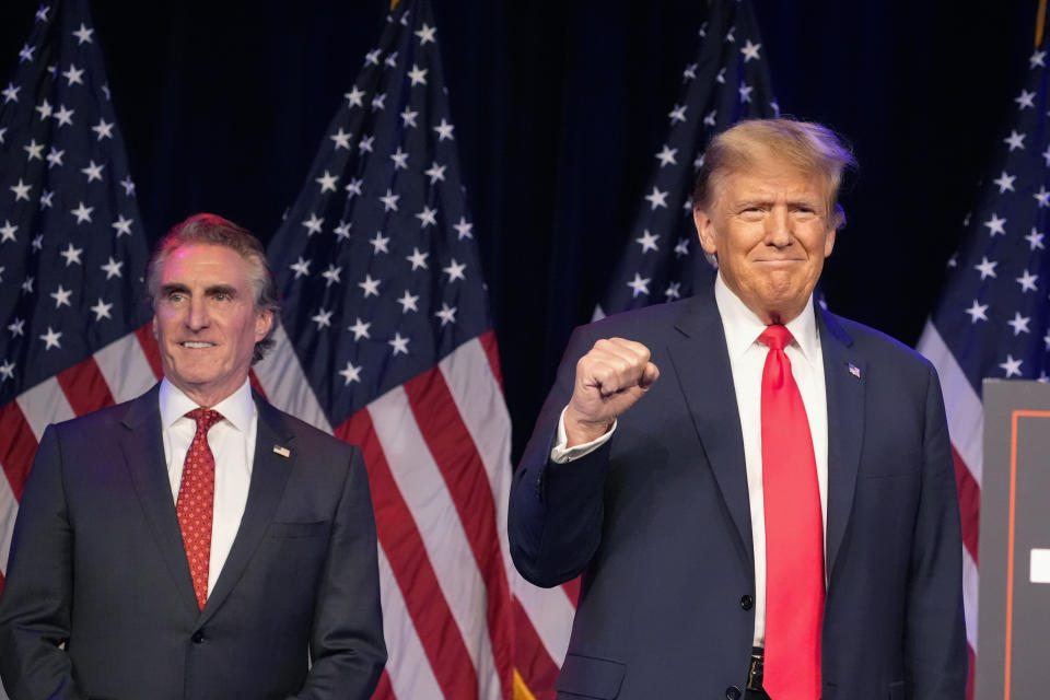 FILE - Republican presidential candidate former President Donald Trump, right, and North Dakota Gov. Doug Burgum attend a caucus night rally in Las Vegas, Feb. 8, 2024. Burgum is one of Trump’s most visible and vocal backers, sprinting around the country to drum up support while auditioning to be his running mate. Meanwhile, Burgum is wrestling with a mammoth carbon dioxide pipeline project in his home state. The $5.5 billion venture has split North Dakota and left him straddling an awkward political divide as Trump and President Joe Biden offer voters starkly different visions of America. (AP Photo/Alex Brandon, File)