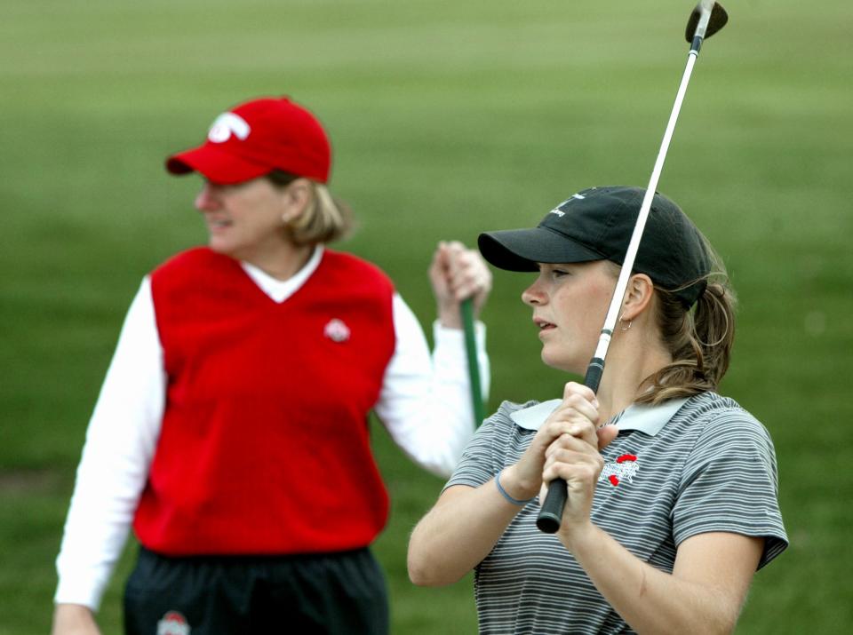 (GOLF23 MERZ SQUILLANTE 4/21/04) Coach Therese Hession (CQ), left, works with OSU golfer Allison Hanna (CQ), right, on her shots from the rough. (Dispatch photo by Fred Squillante.)