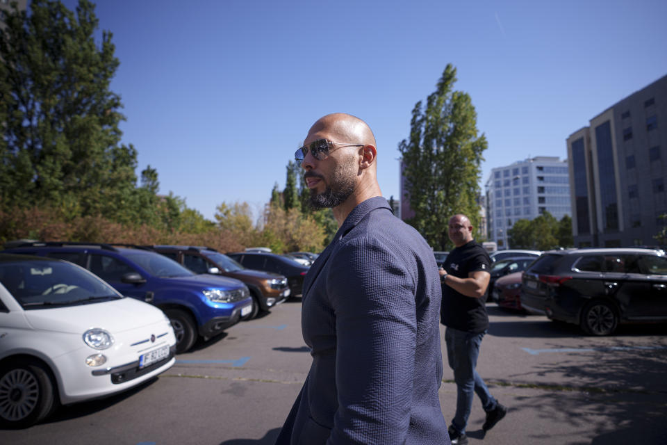 Andrew Tate turns away to look at media as he leaves the Bucharest Tribunal, in Bucharest, Romania, Tuesday, Sept. 26, 2023. Andrew Tate and his brother Tristan, who both face human trafficking charges in Romania, appeared on Tuesday at a court in Romania's capital, Bucharest, to ask that the current judicial measures imposed on them be lifted as well as measures that saw a number of their assets seized during investigations. (AP Photo/Andreea Alexandru)