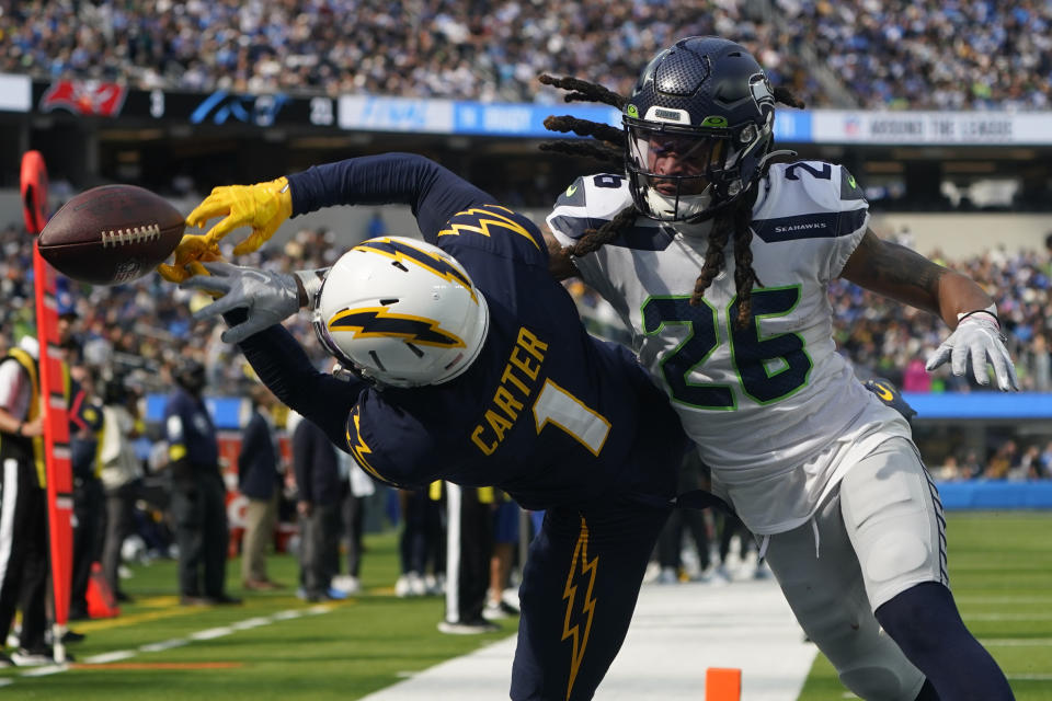 Seattle Seahawks safety Ryan Neal (26) breaks up a pass intended for Los Angeles Chargers wide receiver DeAndre Carter (1) in the end zone during the first half of an NFL football game Sunday, Oct. 23, 2022, in Inglewood, Calif. (AP Photo/Marcio Jose Sanchez)