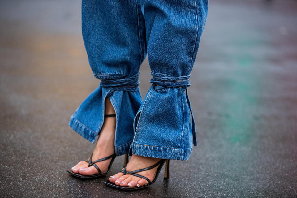 PARIS, FRANCE - FEBRUARY 28: Gitta Banko is seen wearing Tie-Cut high-rise boyfriend jeans by Loewe, black Ankle-strap sandals with an elongated square sole during Paris Fashion Week - Womenswear Fall/Winter 2020/2021 : Day Five on February 28, 2020 in Paris, France. (Photo by Christian Vierig/Getty Images)