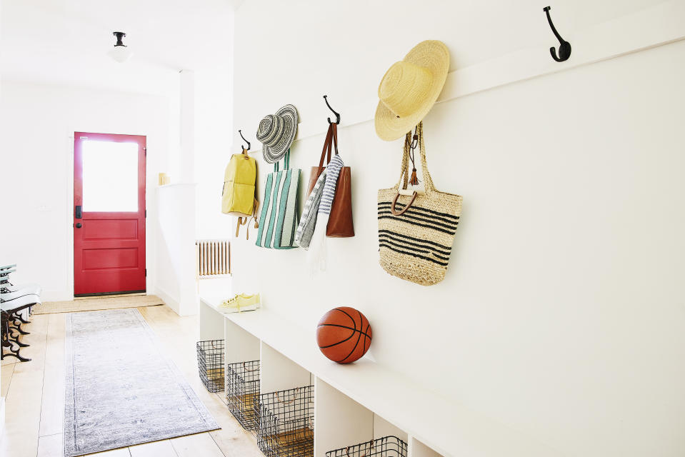 Bags and hats on hooks in entryway of home